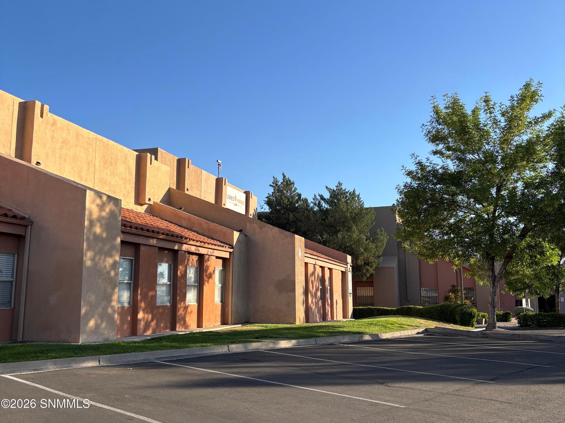 Stucco commercial building exterior at 1980 E Lohman Avenue, Las Cruces, New Mexico.