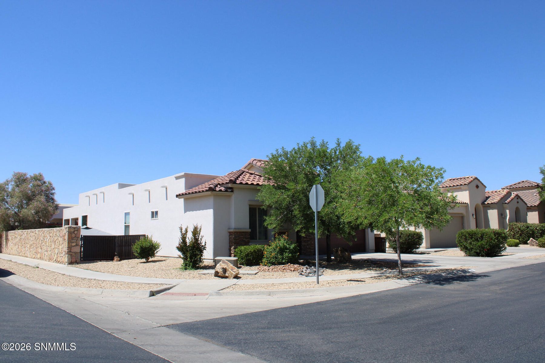 Front exterior of a one story stucco home with a flat roof at 3688 Albion Avenue in Las Cruces, New Mexico.